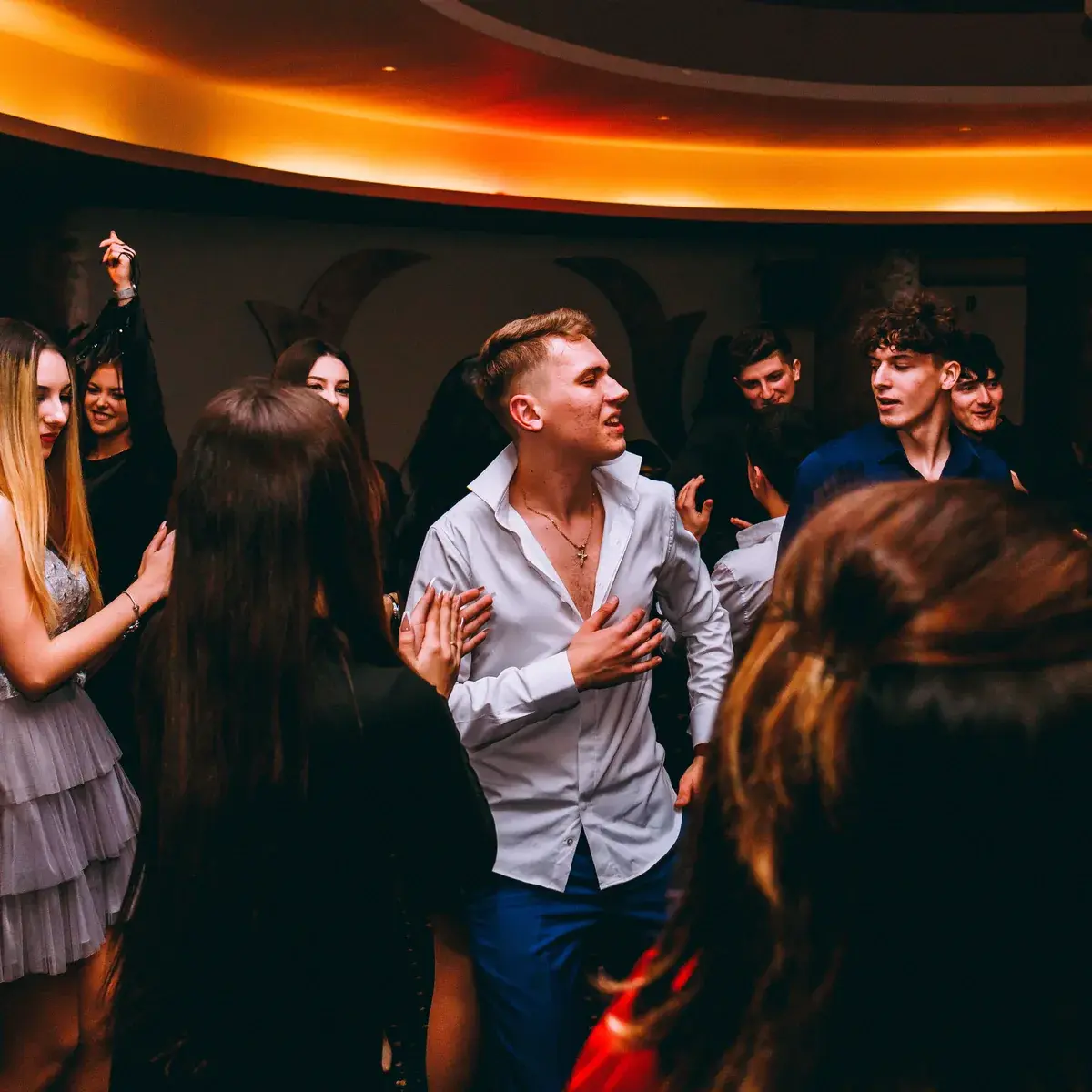 Friends dancing together at an indoor party